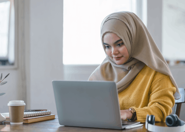 A translator checks an academic transcript and seals the file, delivering Arabic Translation Services in Pittsburgh.