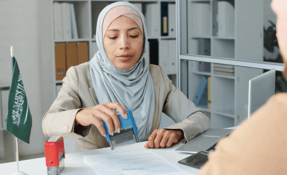 An arabic translator stamps and checks a passport packet, showing Arabic Translation in Pittsburgh for official documents.