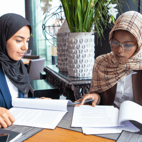 Translators check an Arabic visa packet for USCIS certified compliance using Arabic Translation Services in Pittsburgh.