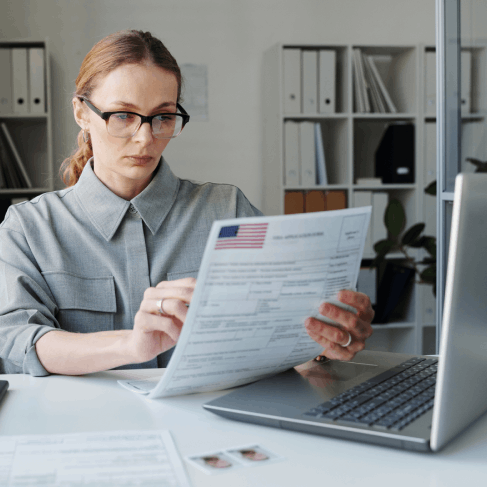 A translator checks a Spanish birth certificate against USCIS rules in Pittsburgh, preparing Spanish Translation Services.